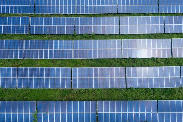 Solar panels on a meadow photographed from birds perspective
